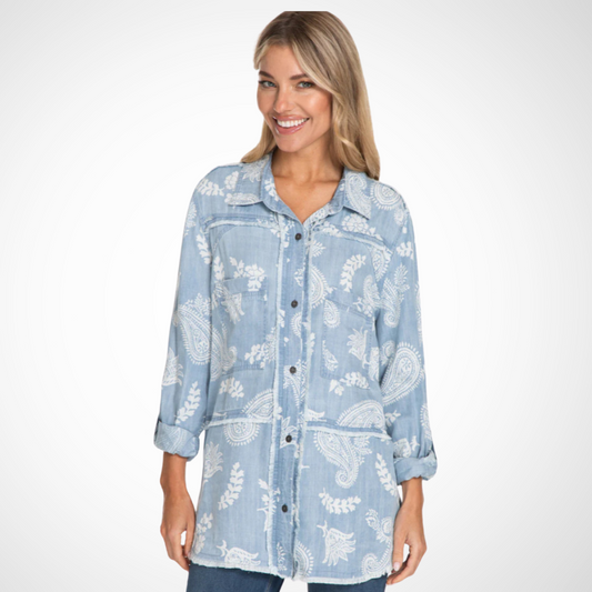 Jaboli Boutique - Fergus Ontario - Multiples - Chambray Pailsey Print Shirt. Introduction: Multiples Denim Chambray Shirt Features a chic white paisley print on a refreshing blue base Tunic-length blouse with a modern frayed hem Roll-tab long sleeves and button front for style and utility Two pockets for functionality Crafted from lyocell print twill fabric Style #M14607BM Offers supreme comfort and elegance