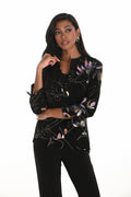 Frank Lyman | Black/Multi Jacket | 259163
A women's black stretch knit jacket featuring painterly metallic and pastel brushstroke accents. Designed with a chrome button closure, mandarin collar, and an asymmetric hemline for a modern silhouette. The jacket has 3/4 sleeves and a soft, unlined structure for breathable comfort and easy layering.
