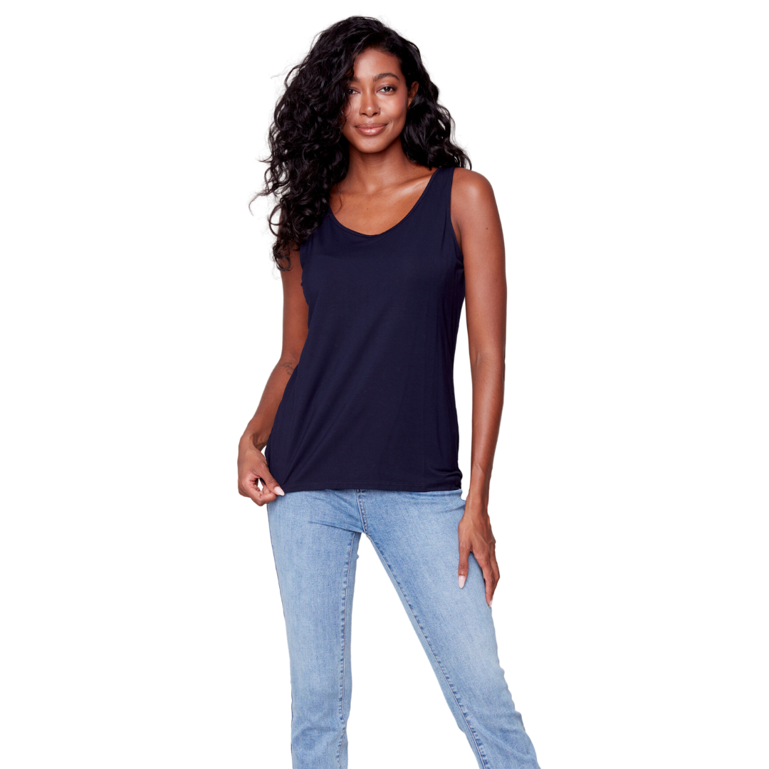 Jaboli Boutique - Fergus Ontario - Charlie B Navy Takn Top. Discover the beauty of our essential Navy Blue Cami.  This fitted cami boasts a timeless V-neck design, guaranteeing a flattering and sophisticated appearance for every event. It's perfect for layering beneath your favorite cardigan, sweater, blazer, or moto jacket, adding versatility and style to your wardrobe.