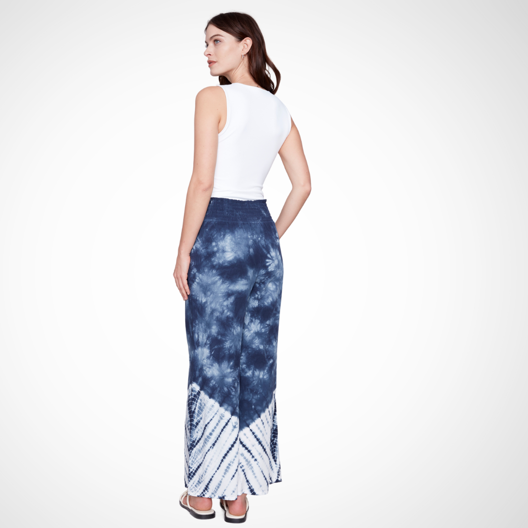 Jaboli Boutique - Fergus Ontario - Charlie B - Palazzo Tie Dye Pant. Charlie B Palazzo Tie Dye Pant transitions from Navy to White Smocked waist and wide-leg silhouette Crafted from 100% Viscose fabric 30" inseam, 15.5" leg opening Ideal for various activities Versatile summer wardrobe staple