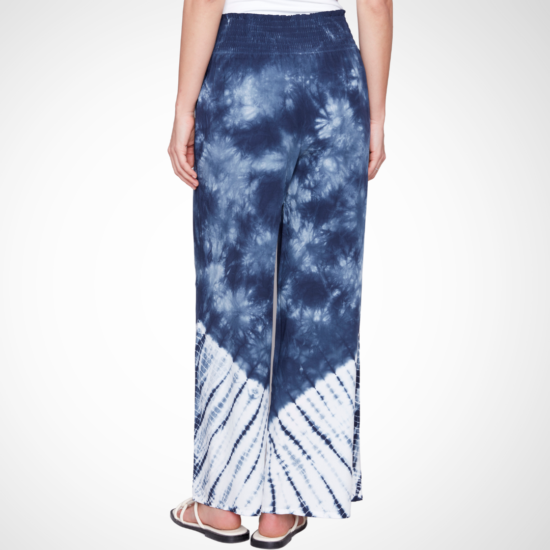 Jaboli Boutique - Fergus Ontario - Charlie B - Palazzo Tie Dye Pant. Charlie B Palazzo Tie Dye Pant transitions from Navy to White Smocked waist and wide-leg silhouette Crafted from 100% Viscose fabric 30" inseam, 15.5" leg opening Ideal for various activities Versatile summer wardrobe staple