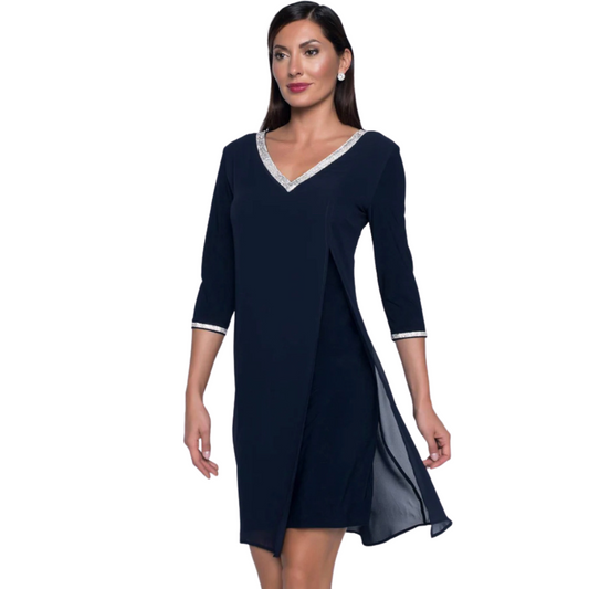 Jaboli Boutique - Fergus Ontario - Frank Lyman V Neck Midnight Navy Dress: Elevate elegance with rhinestone trim. Luxurious Midnight Navy hue with Silver Rhinestone Accent for added glamour. Sophisticated dress with chiffon overlay in Midnight Navy. Knee-length silhouette for a graceful touch. 3/4 sleeves with rhinestone cuffs amplify the refined charm. Proudly made in Canada, reflecting a commitment to quality craftsmanship and contemporary design. 