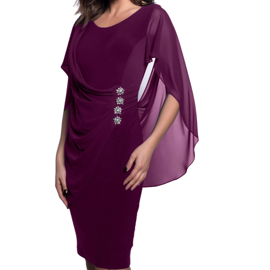 Jaboli Boutique, Fergus Ont, Frank Lyman Sangria Party Dress: Captivating cocktail-length ensemble for style and comfort. Gracefully draped silhouette flatters the figure and allows ease of movement. Ideal choice for any festive occasion. Scoop neckline adds a touch of sophistication. Rich Sangria (Berry) hue exudes vibrancy. Crafted from jersey fabric with a double-layered design. Rhinestone button accent adds a hint of glamour. Knee-length finish for elegance and versatility.