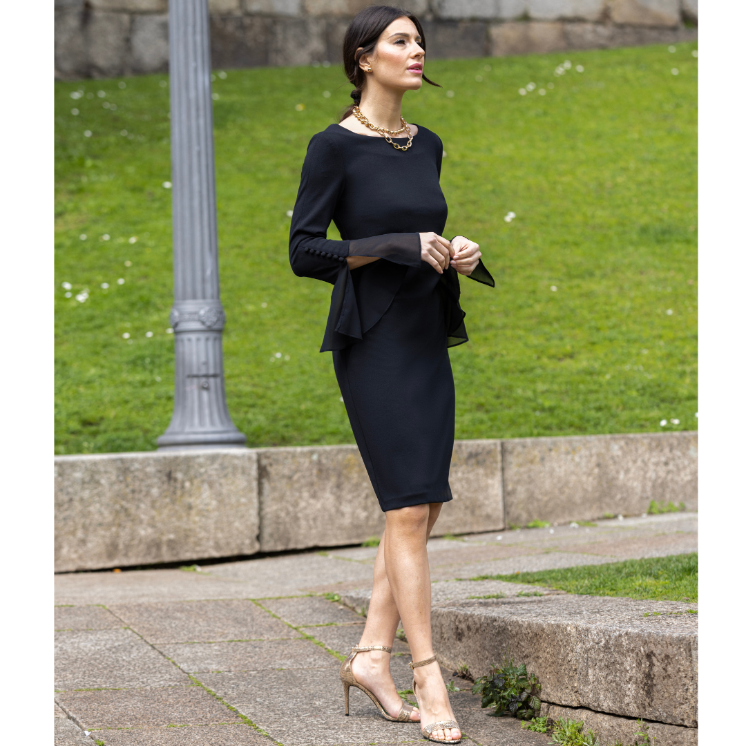 Jaboli Boutique - Fergus ontario - Frank Lyman Black Party Dress. A Classic with a fun twist to the sleeves. A gorgeous little black dress.  A Boat Neckline  Colour - Black Crepe Jersey (Stretch)  Fitted  Long Sleeves with Ruffle Cuff and Button Accent  Knee Length  Proudly Made In Canada!