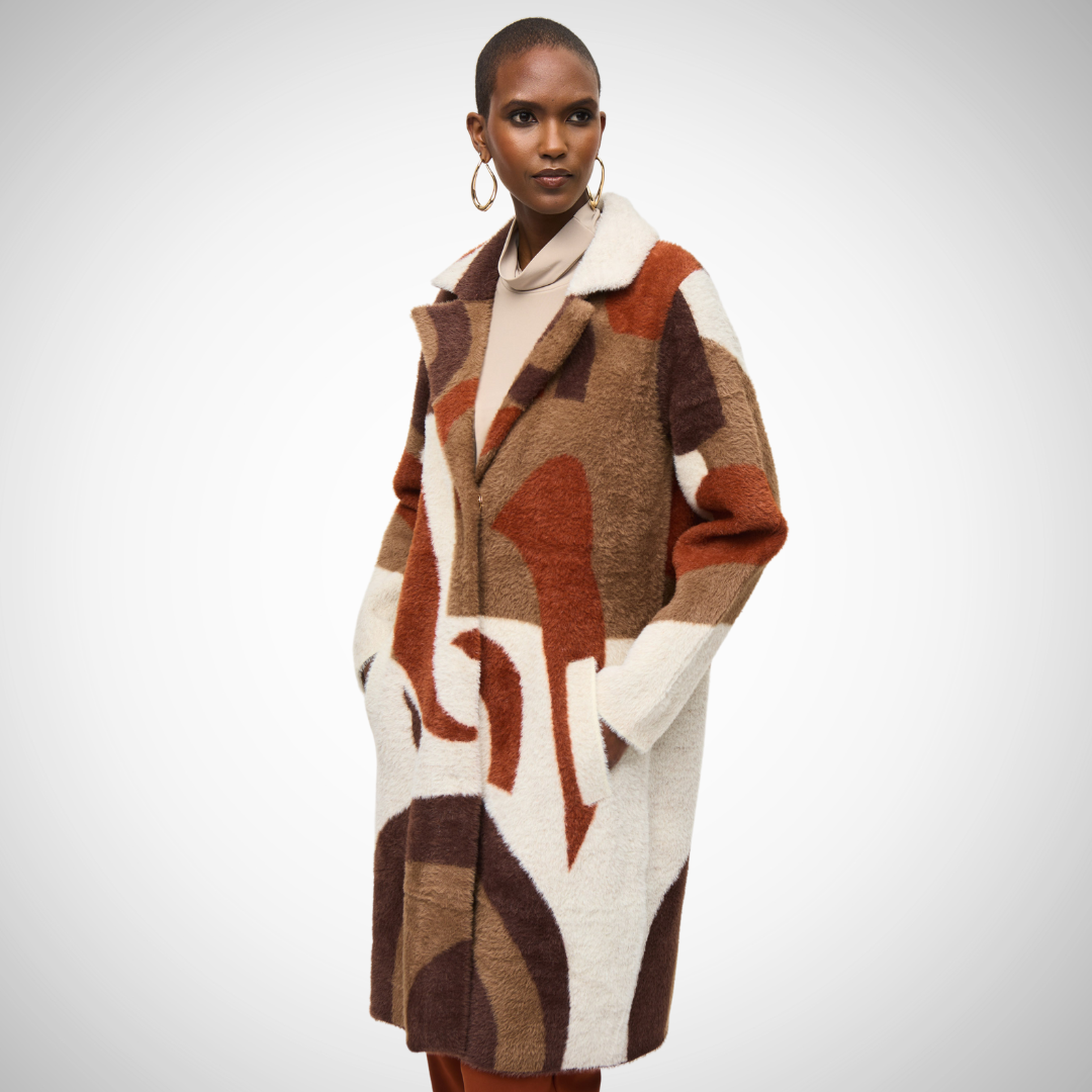 Jaboli Boutique - Fergus Ontario - Joseph Ribkoff - Oversized, Abstract, Cinnamon Coat. Joseph Ribkoff cinnamon coat, thigh-length Oversized fit, straight long sleeves Notched collar, modern abstract pattern Perfect for Fall/Winter; casual yet sophisticated Comfortable, mysterious closure Made of 85% nylon, 15% polyester Side pockets, tuxedo collar Unique cinnamon multi-color