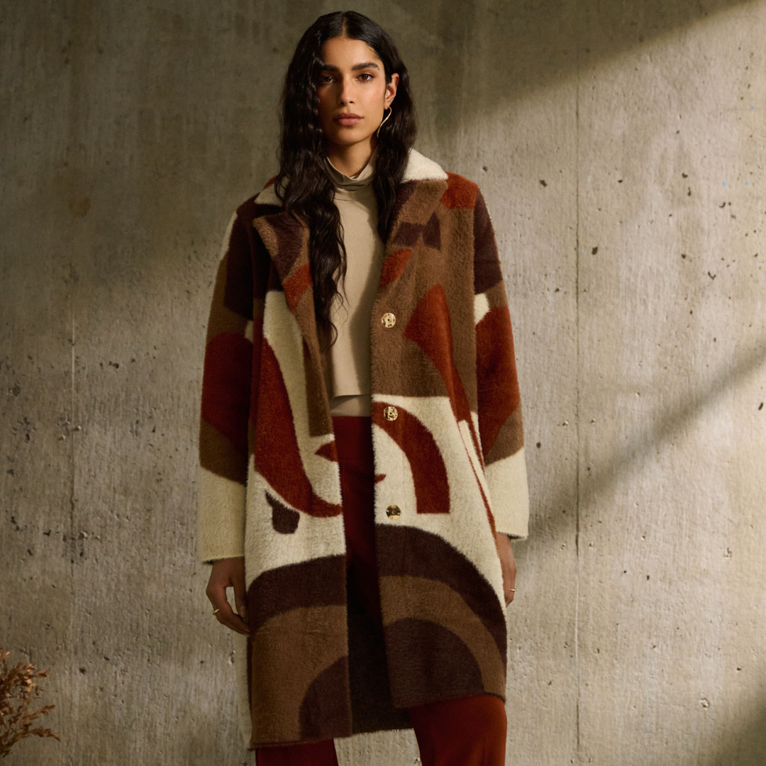 Jaboli Boutique - Fergus Ontario - Joseph Ribkoff - Oversized, Abstract, Cinnamon Coat. Joseph Ribkoff cinnamon coat, thigh-length Oversized fit, straight long sleeves Notched collar, modern abstract pattern Perfect for Fall/Winter; casual yet sophisticated Comfortable, mysterious closure Made of 85% nylon, 15% polyester Side pockets, tuxedo collar Unique cinnamon multi-color