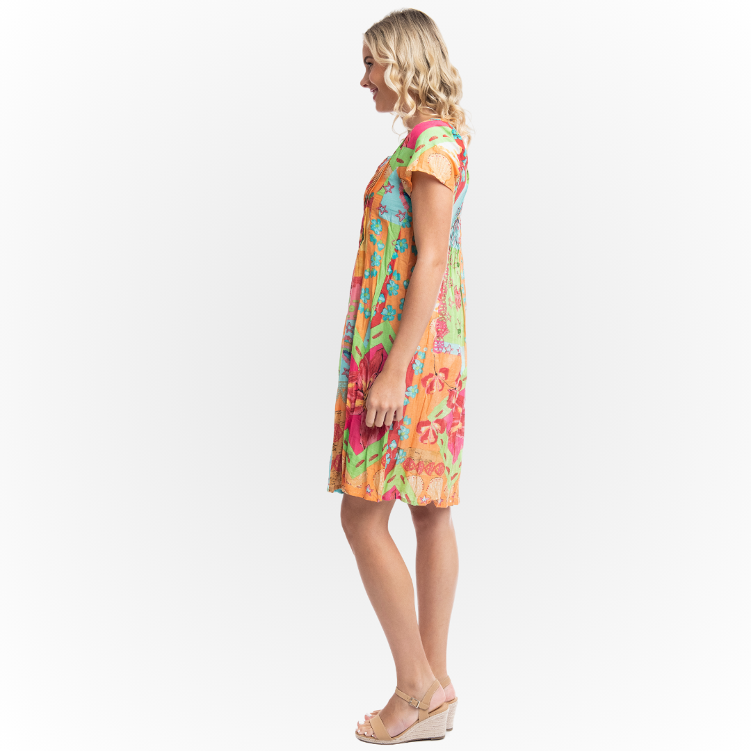 The Orientique Aiya Napa Dress.   A gorgeous light weight  summer dress that packs a punch of tropical colour,   Vee Neck, Short Sleeve Organic Cotton Fabric,  Colours - Fresh Lime, Orange, Turquoise Print,  Pin Tuck Bodice,  Full Crinkle Skirt,  Knee Length,  Knee length,   A-line silhouette. 