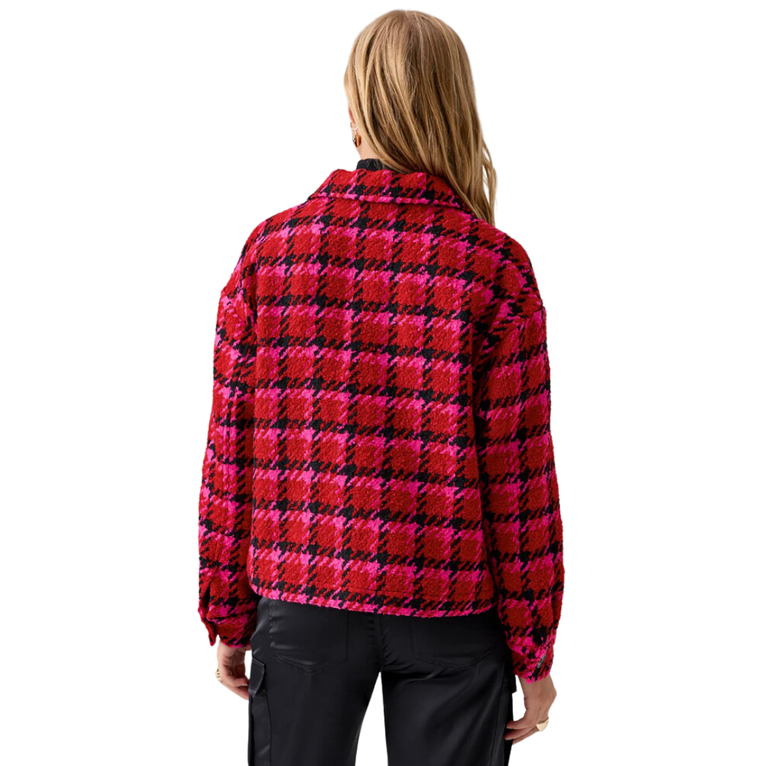 Jaboli Boutique - Fergus Ontario - Sanctuary - Lipstick Red Plaid Jacket. The Cutest Plaid Shacket for adding a pop of color during colder months. Features a waist-length design and a striking Red/Fuchsia/Black Houndstooth Print. Seamlessly combines style and warmth with cozy woven fabric. Offers a relaxed fit for ultimate comfort. Two functional chest flap pockets and four center front buttons for practicality and charm. Ideal choice for staying stylish and snug during the chilly season.