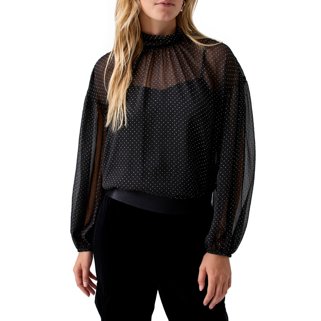 Jaboli Boutique - Fergus ontario - Sanctuary - Sheer Metallic Blouse. The Silver Dot Blouse: Perfect for completing your date night ensemble. Adds a touch of soft feminine charm to your look. Classic Black with Silver Polka Dots exudes timeless elegance. A two-piece blouse that includes a camisole for a chic and comfortable layered style. Features a mock neckline and blouson sleeves for added sophistication. Black blouse with silver dots.