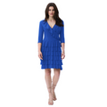 Jaboli boutique Fergus Ontario - Joseph Ribkoff Oasis Blue colour dress. This dress is designed to make a statement with its playful features. The faux wrap style adds a touch of sophistication, while the knee-length cut strikes the perfect balance between elegance and fun. The 3/4 sleeves provide a chic look, and the V neckline with ruffle asymmetrical bodice detail adds a touch of charm. To complete the look, the dress boasts a tiered ruffle skirt