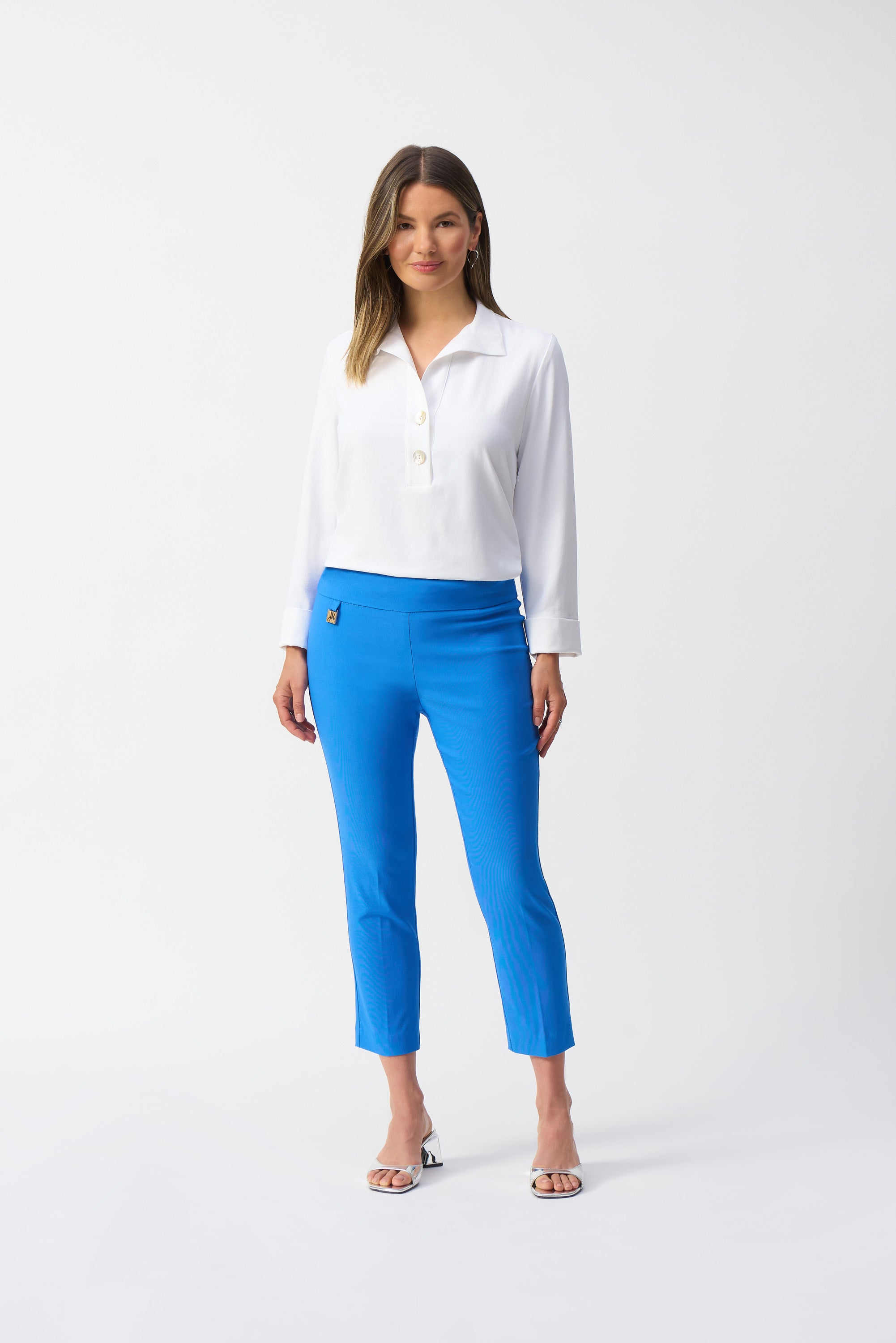 Jaboli Boutique-Fergus Ontario-Joseph Ribkoff Cropped Slim Pant (Style 201536S25): Luxurious high-waisted pants made from a soft, stretchy blend of viscose rayon, nylon, and spandex. Featuring a modern slim fit , high rise and cropped length, these pants are perfect for spring, showcasing your favorite footwear. Made in Canada for superior craftsmanship, ideal for both casual and formal settings. Available in coastal blue colours.