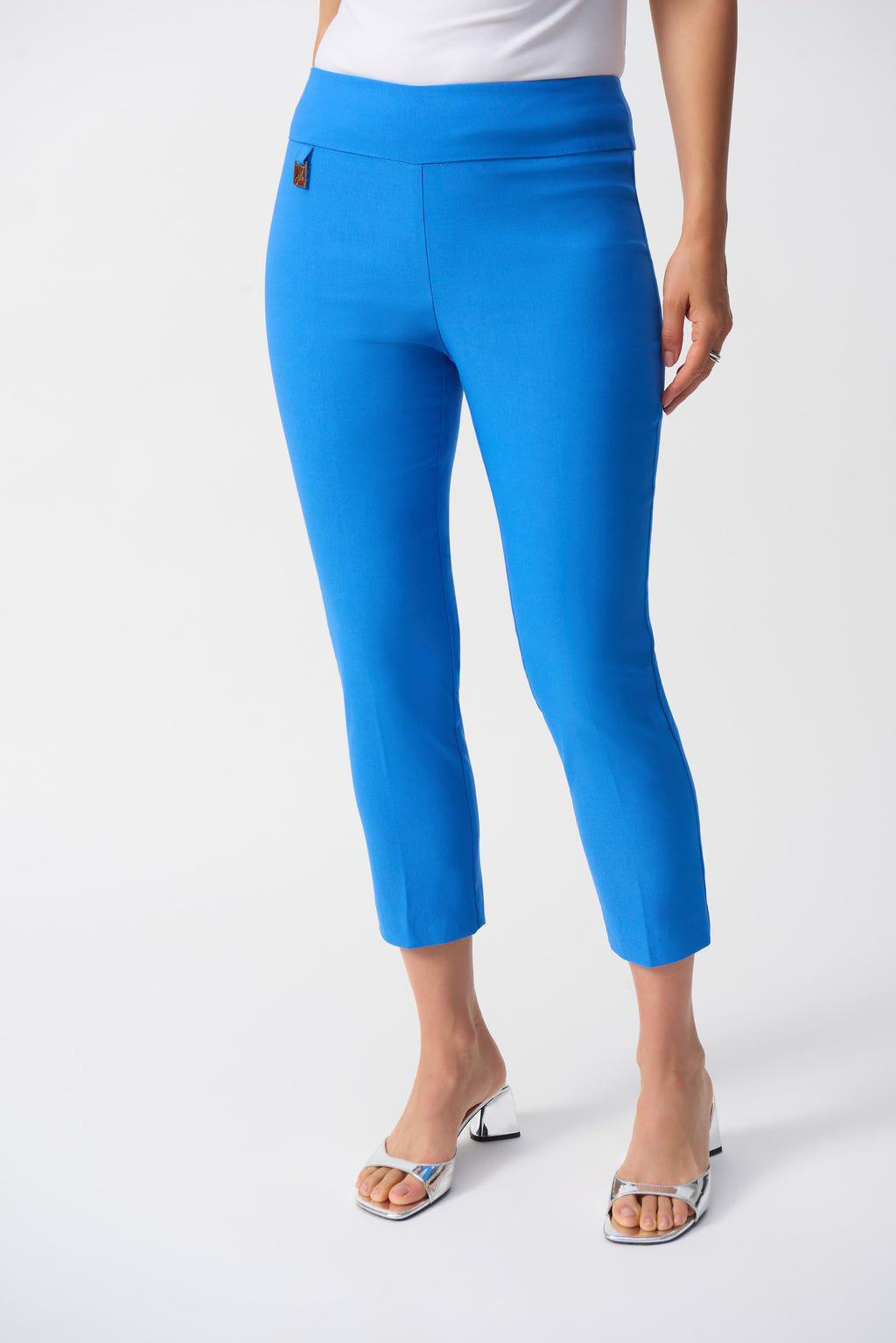 Jaboli Boutique-Fergus Ontario-Joseph Ribkoff Cropped Slim Pant (Style 201536S25): Luxurious high-waisted pants made from a soft, stretchy blend of viscose rayon, nylon, and spandex. Featuring a modern slim fit , high rise and cropped length, these pants are perfect for spring, showcasing your favorite footwear. Made in Canada for superior craftsmanship, ideal for both casual and formal settings. Available in coastal blue colours.