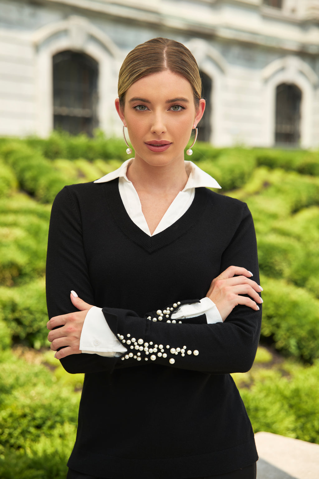  Jaboli Boutique-Fergus Ontario-Pearl Fooler Top-244627U-colour black-This Frank Lyman sweater showcases a sleek black body with a v-neck design, a shirt-style collar, and long sleeves adorned with pearl-encrusted cuffs. Its hip-length, regular fit makes it ideal for work or special events, offering a touch of elegance with layered pearls and timeless style. Crafted from a 50% Rayon, 30% Polyester, and 20% Polyamide blend, it combines comfort and sophistication effortlessly.