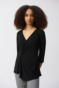 Jaboli Boutique- Fergus Ontario -Joseph Ribkoff - Black Tunic (Style 251232) from the Spring 2025 collection, featuring a silky knit fabric, V-neckline, elbow-length sleeves, shirring at the waist, and an asymmetrical draped hem for a flowing, elegant silhouette. Made of 96% Polyester and 4% Spandex, designed for comfort and sophistication.