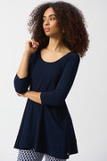 Jaboli Boutique- Fergus Ontario -Joseph Ribkoff Tunic (Style 251969) colour new midnight from the Spring 2025 collection, featuring a luxurious silky knit fabric, scoop neckline, and three-quarter straight sleeves. The relaxed fit and unlined construction provide comfort and versatility, ideal for pairing with jeans, leggings, or skirts. Made in Canada with 95% Polyester and 5% Spandex