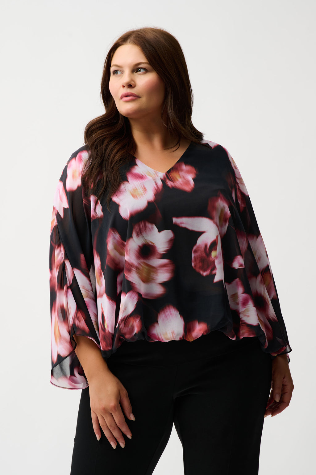 Jaboli Boutique|Fergus Ontario|Joseph Ribkoff | Chiffon Silky Knit Floral Print Cape Top| Joseph Ribkoff black chiffon cape top with pink and rose floral print, featuring V-neckline, dolman sleeves, silky knit waistband, and back bow detail. 100% polyester