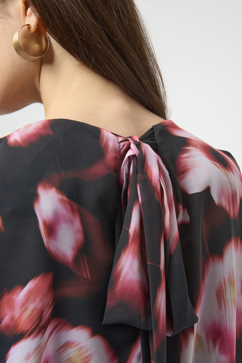 Jaboli Boutique|Fergus Ontario|Joseph Ribkoff | Chiffon Silky Knit Floral Print Cape Top| Joseph Ribkoff black chiffon cape top with pink and rose floral print, featuring V-neckline, dolman sleeves, silky knit waistband, and back bow detail. 100% polyester