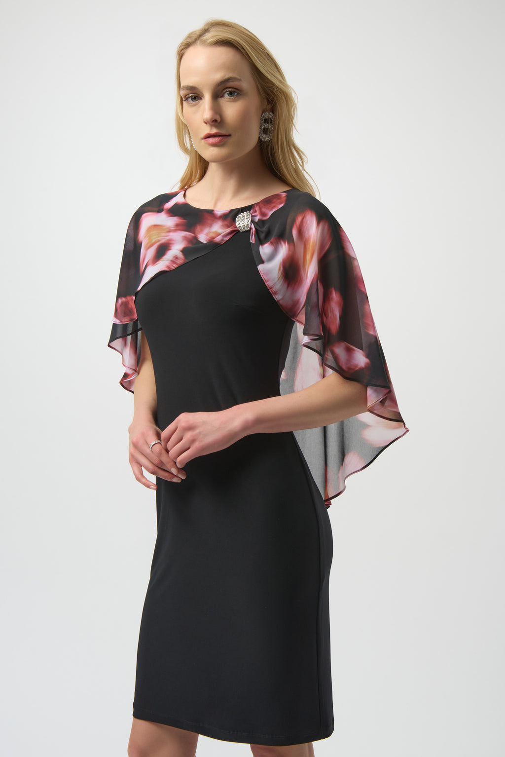 Jaboli Boutique| Fergus Ontario|Joseph Ribkoff | Recycled Floral Chiffon & Silky Knit Layered Dress. Joseph Ribkoff black silky knit sheath dress with recycled chiffon floral cape overlay, rhinestone boat neckline, and cocktail-length silhouette.