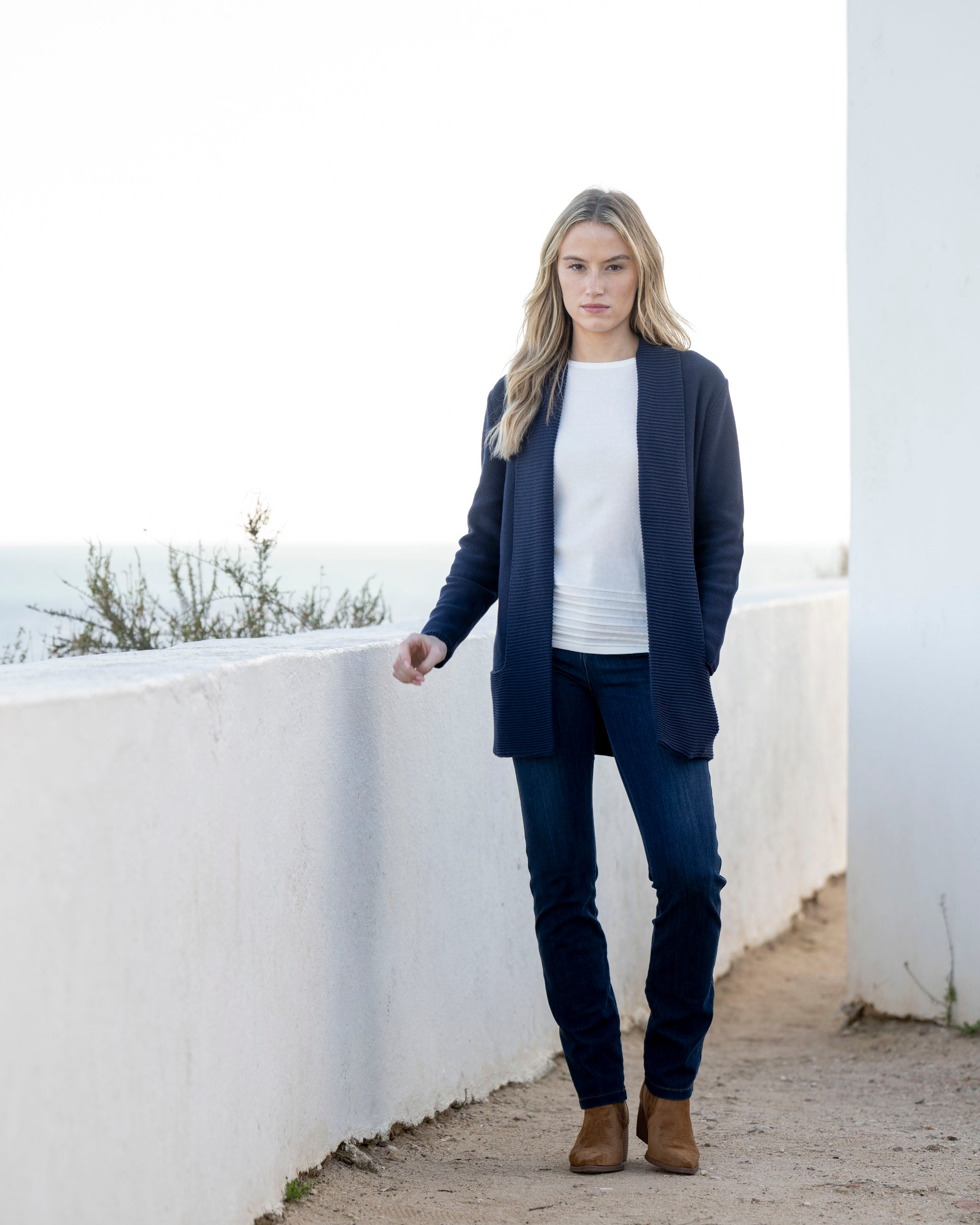 Jaboli Boutique | Fergus Ontario| Marble | Classic Cardigan. Colour Navy.
Marble Classic Cardigan with shawl collar, long sleeves, thigh-length relaxed fit, and pockets, in navy and cognac, perfect for layering over office or casual outfits.