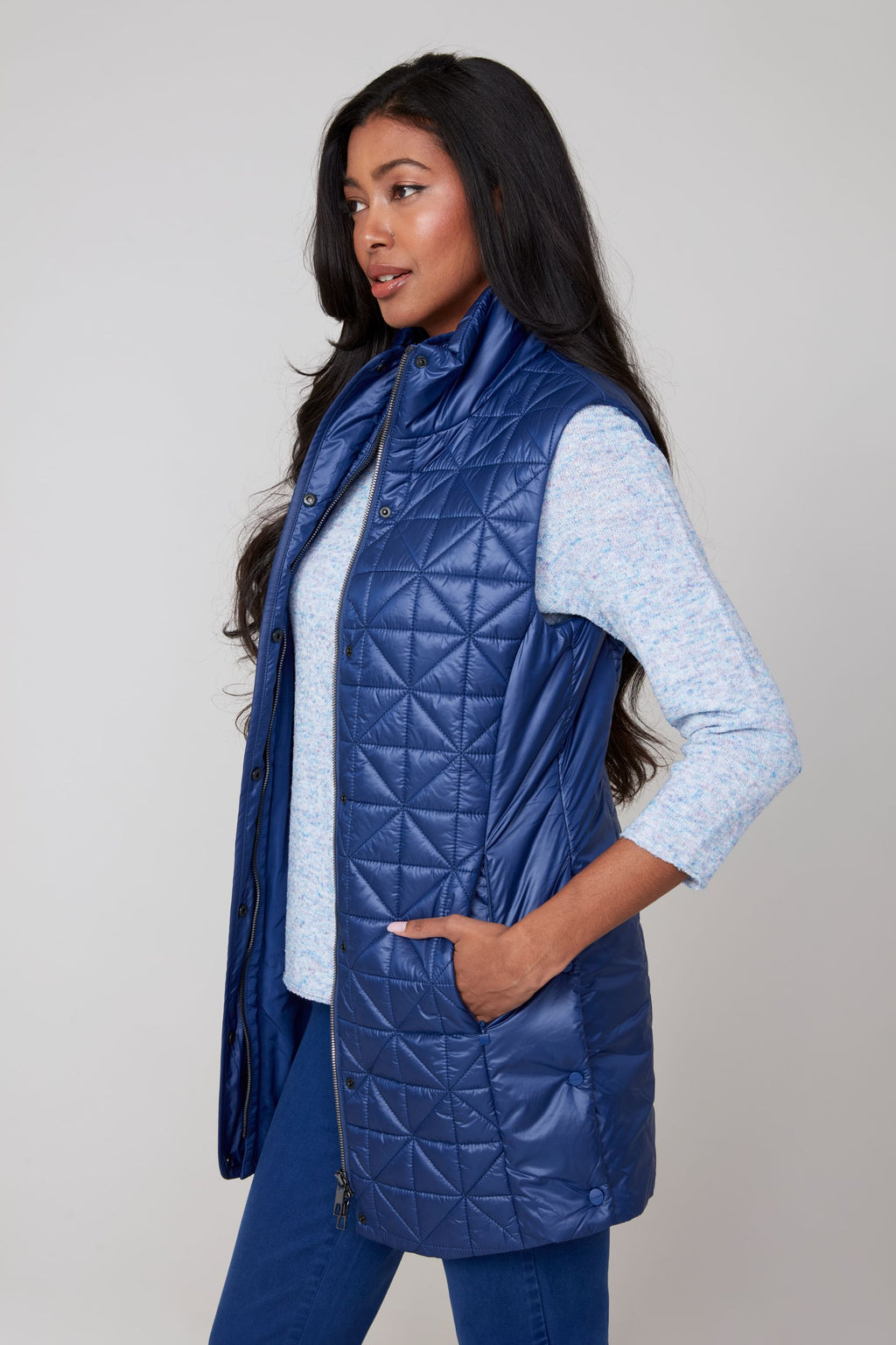 Jaboli Boutique|Fergus Ontario|Renuar| Luxe Long Quilted Vest| colour oxford blue. women’s long quilted vest in Oyster, Oxford Blue, and Porto (Merlot) colours. Features a cozy stand-up collar trimmed with luxe faux fur, a zip and snap front closure for secure layering, and side snaps at the hips for added mobility. The vest has a sleek, slim fit with a 31-inch mid-thigh length, designed as a stylish outerwear piece for fall and winter. Perfect for layering over sweaters and casual chic outfits.