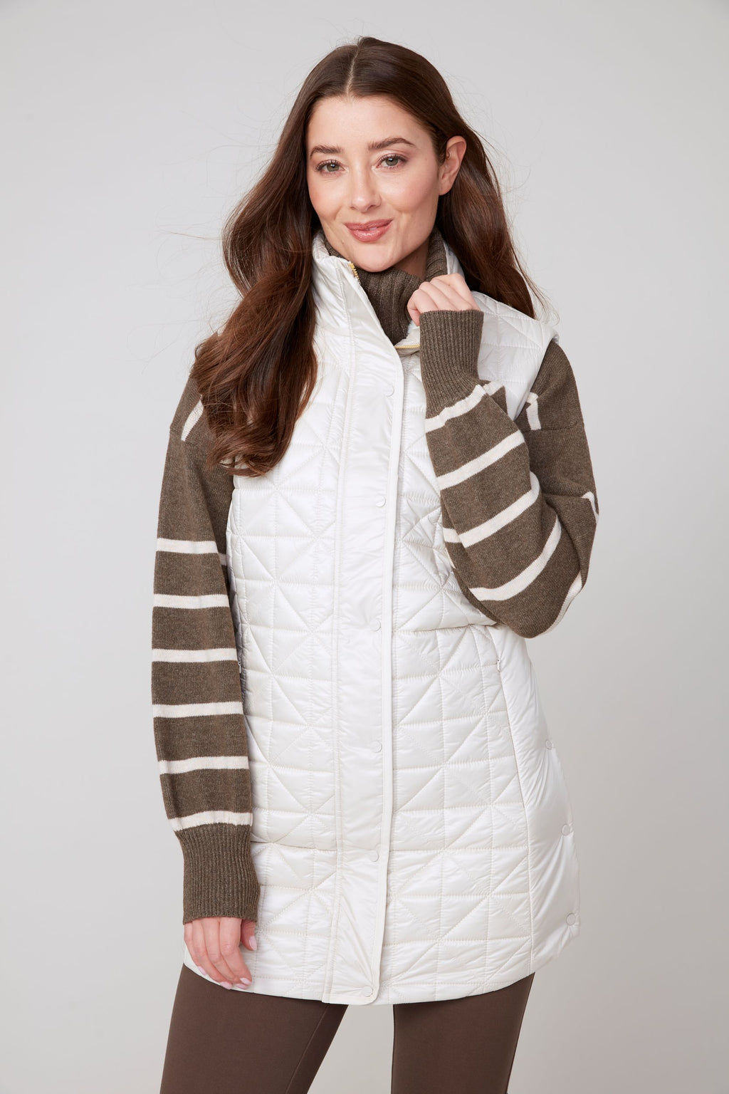Jaboli Boutique|Fergus Ontario|Renuar| Luxe Long Quilted Vest| colour Oyster women’s long quilted vest in Oyster, Oxford Blue, and Porto (Merlot) colours. Features a cozy stand-up collar trimmed with luxe faux fur, a zip and snap front closure for secure layering, and side snaps at the hips for added mobility. The vest has a sleek, slim fit with a 31-inch mid-thigh length, designed as a stylish outerwear piece for fall and winter. Perfect for layering over sweaters and casual chic outfits.