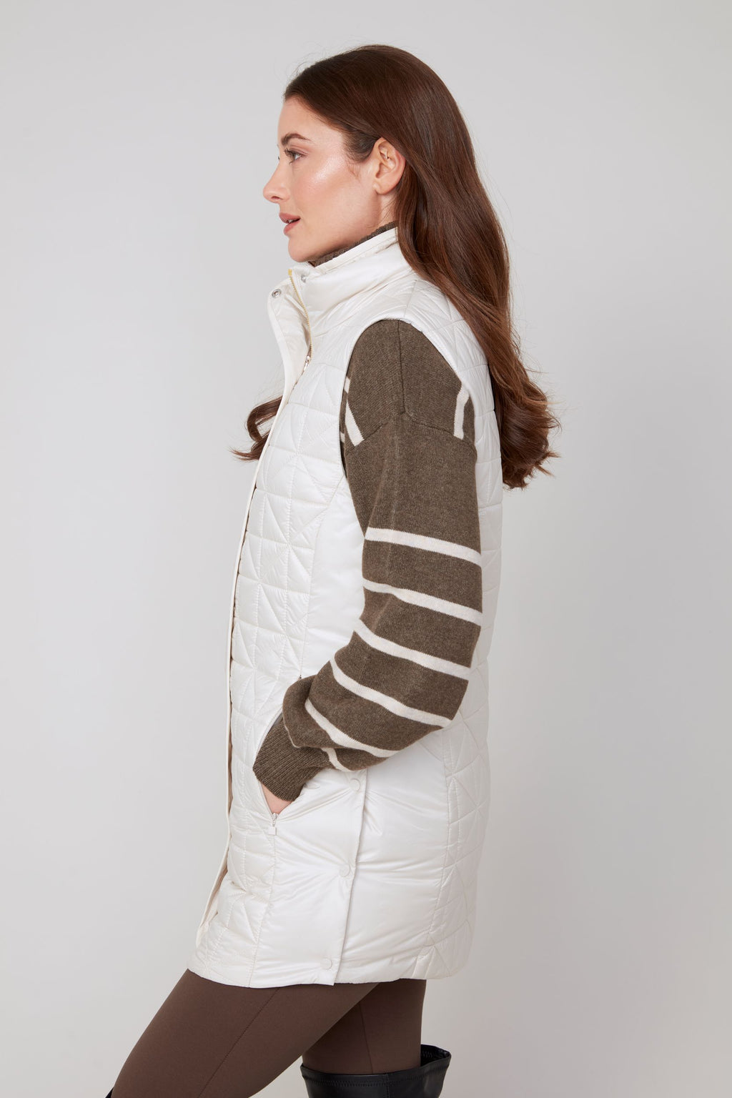 Jaboli Boutique|Fergus Ontario|Renuar| Luxe Long Quilted Vest| colour Oyster women’s long quilted vest in Oyster, Oxford Blue, and Porto (Merlot) colours. Features a cozy stand-up collar trimmed with luxe faux fur, a zip and snap front closure for secure layering, and side snaps at the hips for added mobility. The vest has a sleek, slim fit with a 31-inch mid-thigh length, designed as a stylish outerwear piece for fall and winter. Perfect for layering over sweaters and casual chic outfits.