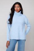 Jaboli Boutique | Fergus Ontario | Renuar | Oxford Blue Cashmere-Feel Knit Sweater.
Renuar women’s pullover sweater in a deep Oxford Blue colour, featuring a relaxed cowl neckline that drapes softly. Made from a cashmere-feel knit fabric, the sweater has long sleeves and a comfortable, relaxed fit designed for cozy layering. The style is versatile for casual or office wear, shown paired with denim and sneakers for a laid-back fall outfit, or with tailored trousers and loafers for a polished winter look.