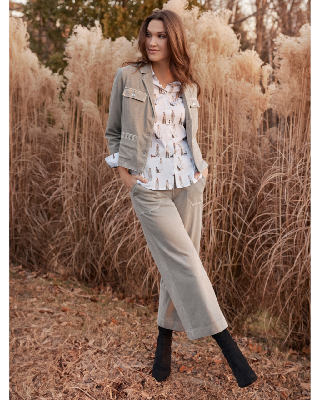 Jaboli Boutque|Fergus Ontario|Renuar|“Walk Your Dog” Button Front Shirt|women’s button front shirt in a crème colour with a playful multi-coloured puppy print. Features a classic collar, buttoned front and cuffs, and a contoured hemline for easy tucking or wearing loose. Made from a comfortable cotton-spandex blend with a tailored fit, perfect for adding a fun, stylish twist to fall and winter outfits. Styled for casual days or dressed-up office looks, ideal for dog lovers who enjoy unique fashion pieces.