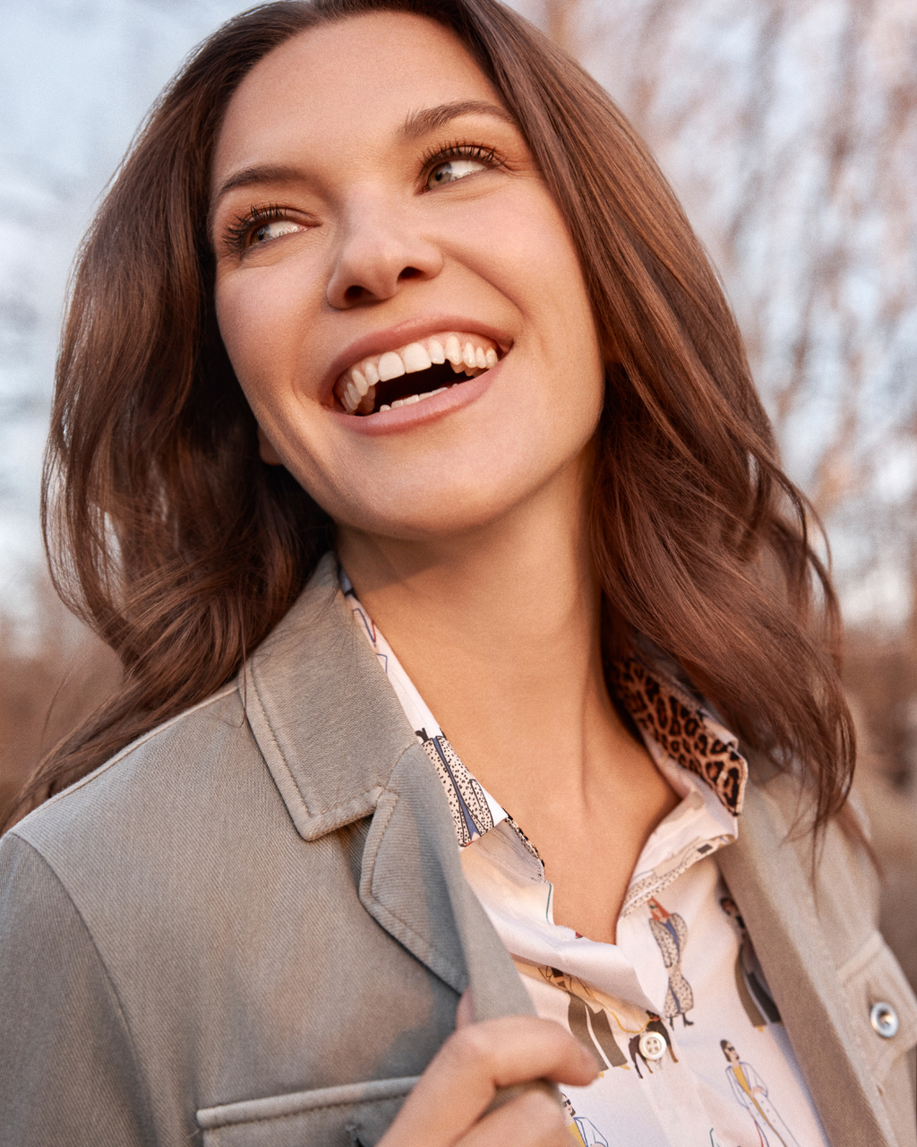 Jaboli Boutque|Fergus Ontario|Renuar|“Walk Your Dog” Button Front Shirt|women’s button front shirt in a crème colour with a playful multi-coloured puppy print. Features a classic collar, buttoned front and cuffs, and a contoured hemline for easy tucking or wearing loose. Made from a comfortable cotton-spandex blend with a tailored fit, perfect for adding a fun, stylish twist to fall and winter outfits. Styled for casual days or dressed-up office looks, ideal for dog lovers who enjoy unique fashion pieces.