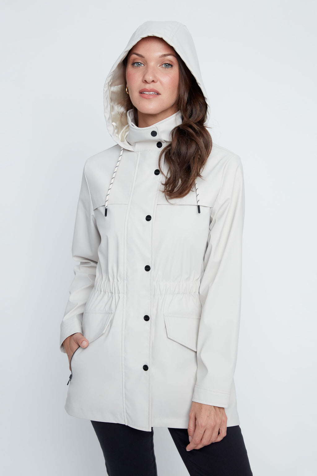 Woman wearing a white hooded coat on a white background