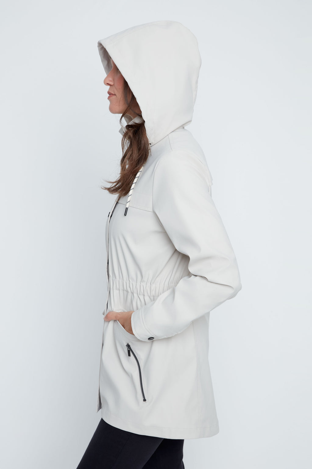Woman wearing a white hooded jacket on a white background