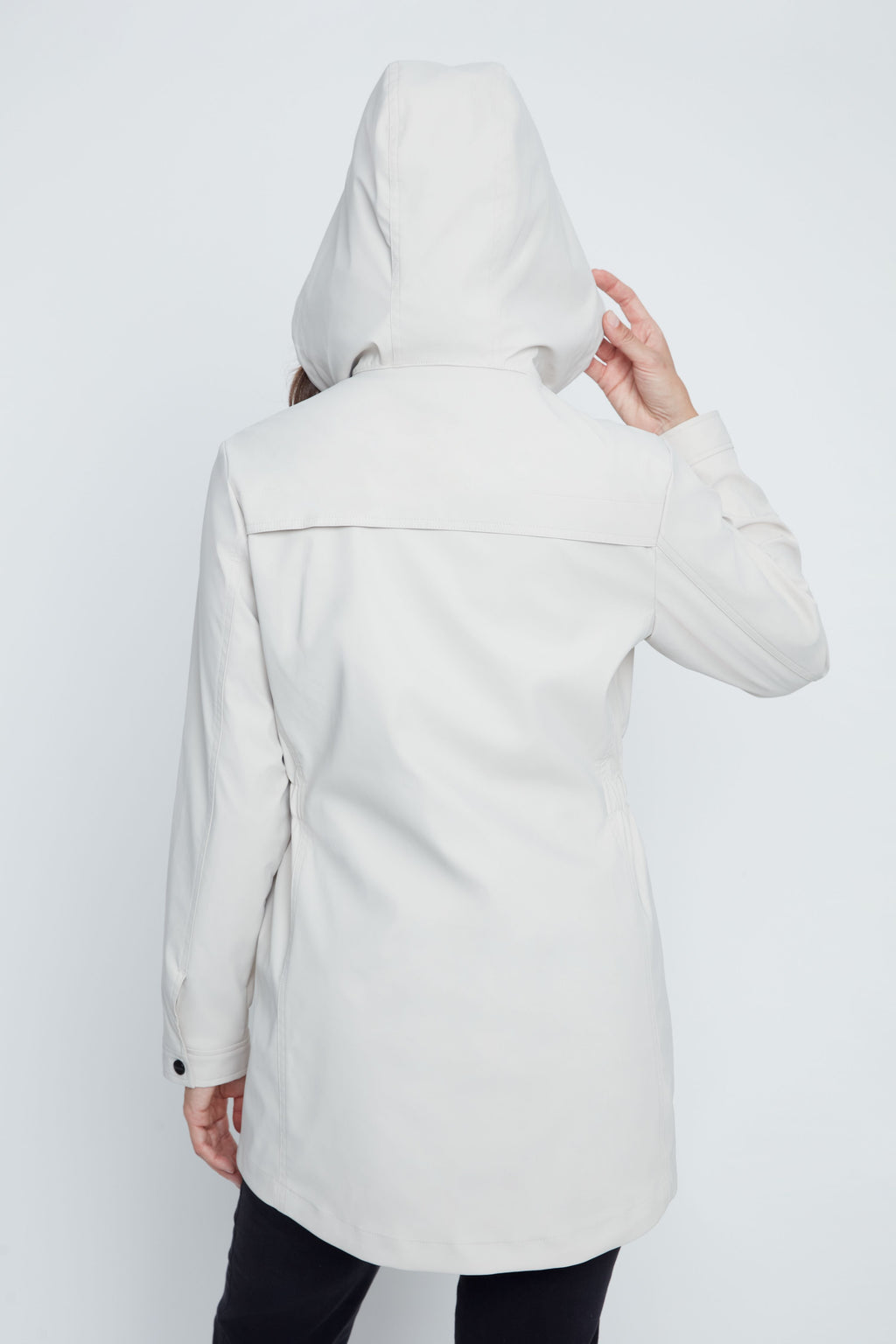 Person wearing a white hooded coat on a white background