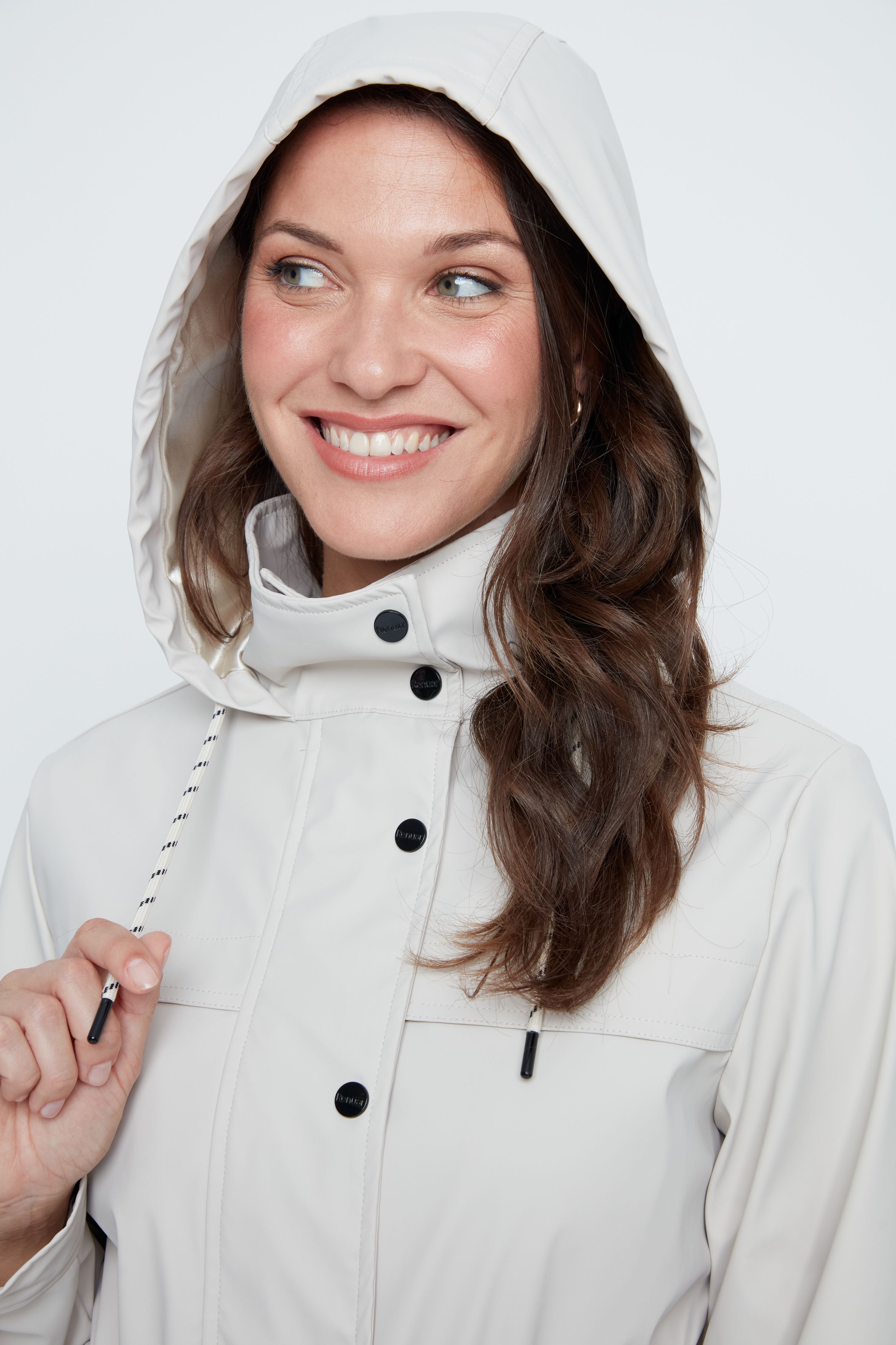 Woman wearing a light gray hooded jacket on a white background