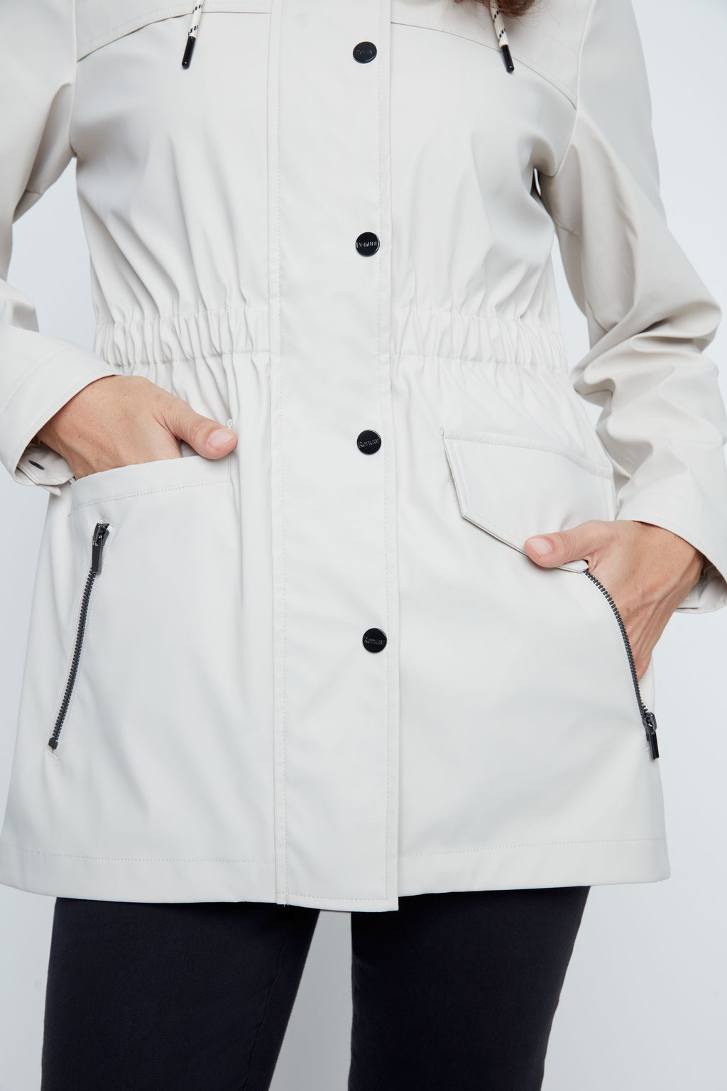 White raincoat with black buttons and zippers on a white background