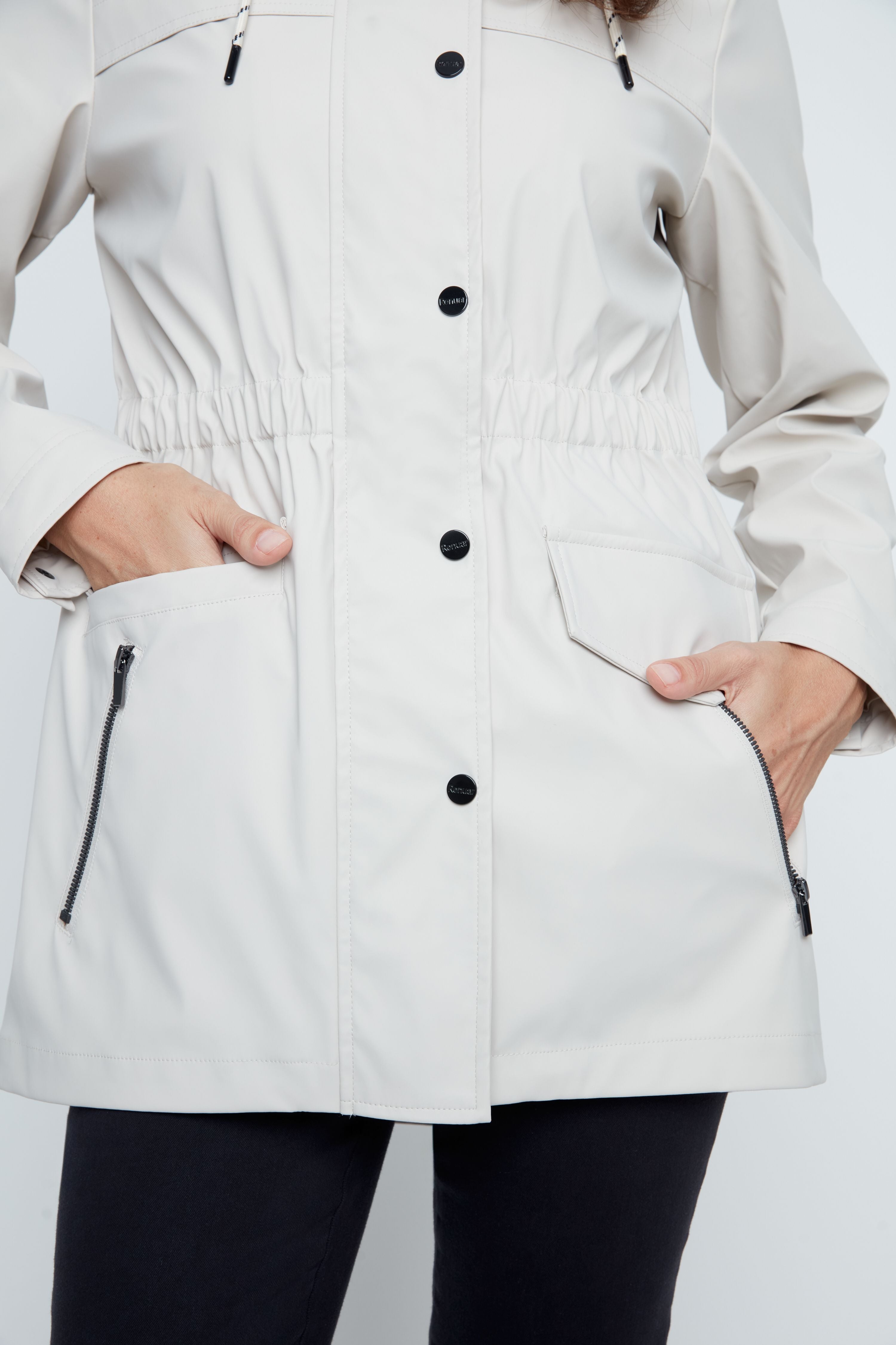 White raincoat with black buttons and zippers on a white background
