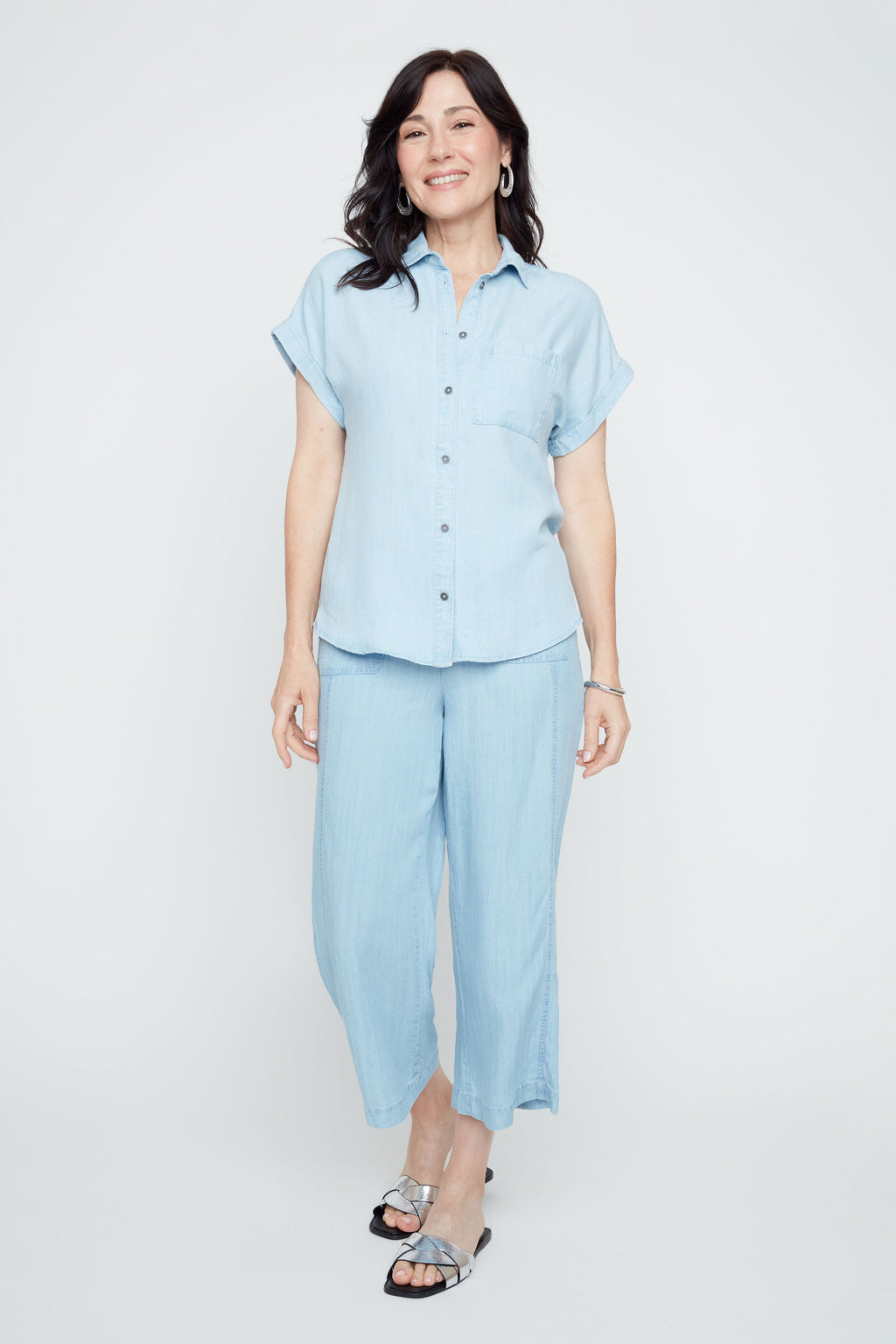 Woman wearing a light blue outfit on a white background