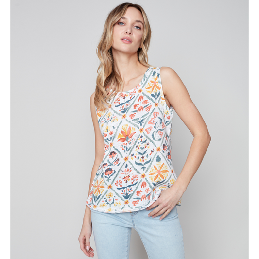 Jaboli Boutique - Fergus Ontario - Charlie B - Printed Sleeveless Top. Multi Coloured Tile Print Tank Top  Round Neckline   Colours Consist Of Orange, Yellow, Sage Green, And Dusty Blue Floral Print On A White Base.  Wear This Tank Top With The Charlie B Essential White Linen Jacket For A Fresh Summer Look.
