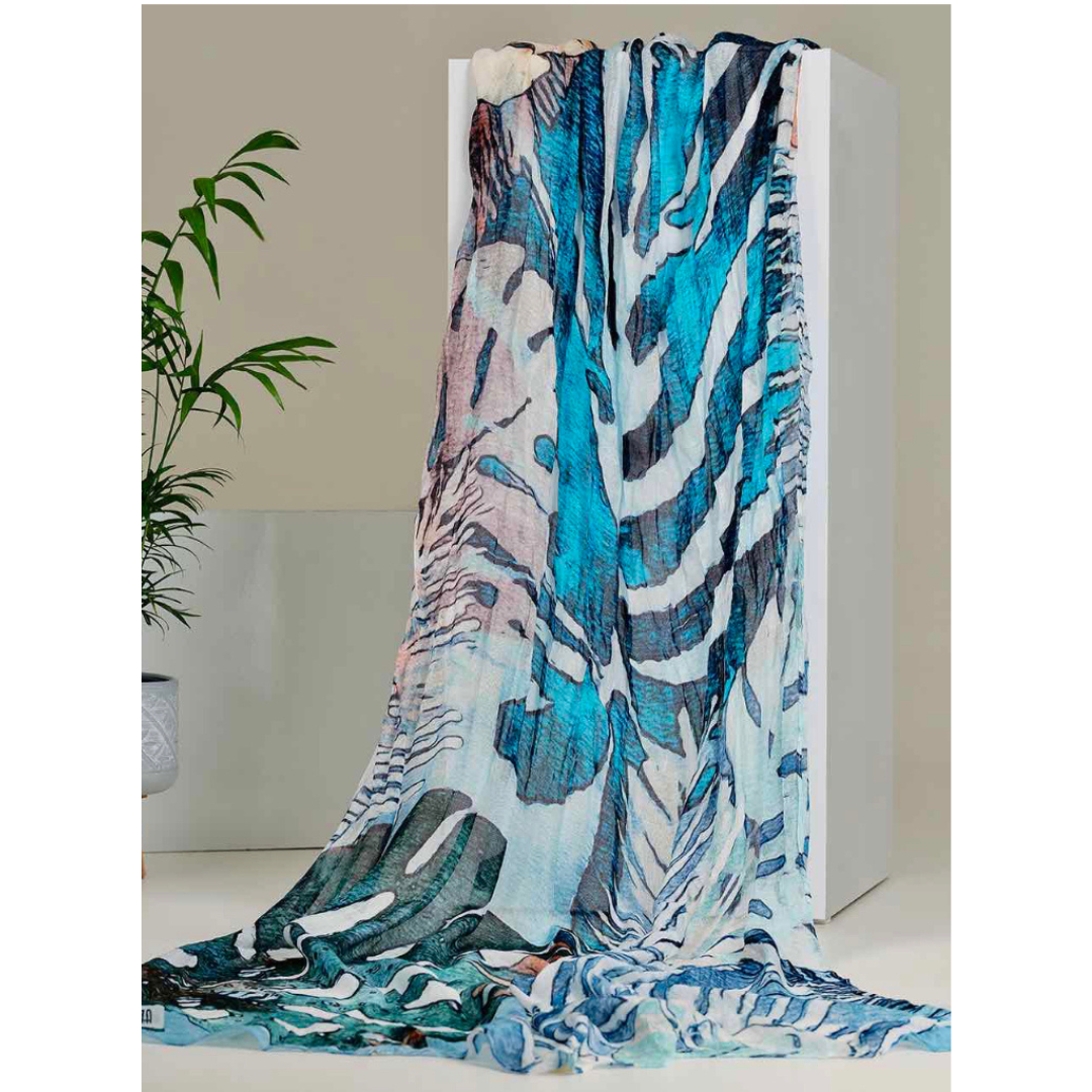 Jaboli Boutique - Fergus Ontario -Dolcezza - Tropical Blue Scarf - a gorgeous array of blues in and abstract  palm/ fern print. Crafted from premium 100% Viscose fabric, the Dolcezza Art Scarf showcases a captivating collection of assorted art prints.  A Gorgeous Summer Accessory 