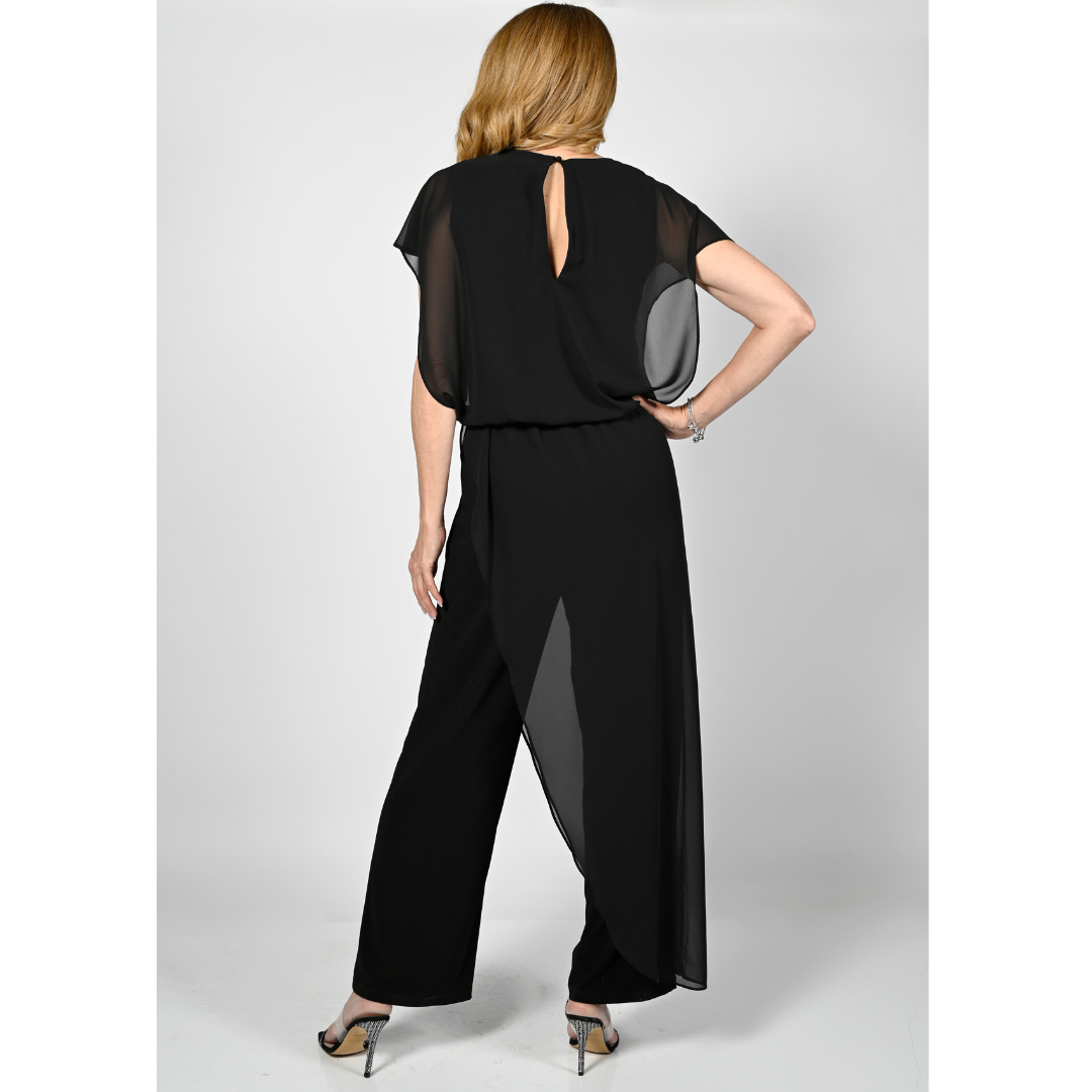 Jaboli Boutique - Fergus Ontario - Frank Lyman - Jumpsuit With Chiffon Overlay. Vee Neck Cap Sleeve Jumpsuit with Blouson Top Chiffon floating over Jersey Special Event Dressy Pair with your Favourite Sparkly Necklace Pictured Is The Jumpsuit In Black. Jumpsuit Is Stocked In Dark Navy Blue.