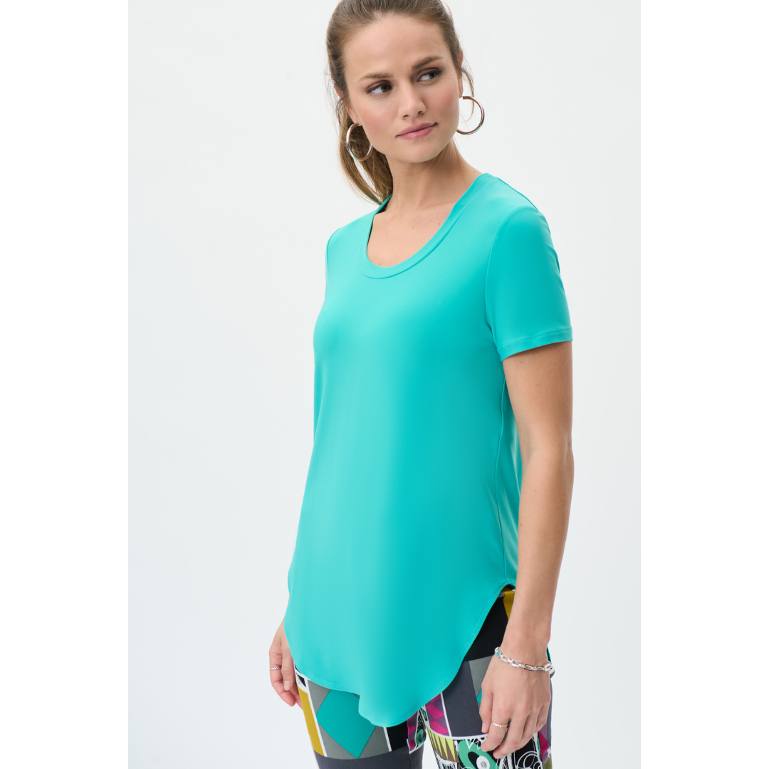 Gorgeous Essential T-Shirt Made Up Of Joseph Ribkoff Classic Jersey Material.  Perfect As A Layering Piece Or Stand Alone Top  Crew Neck,  Short Sleeves,  Sculpted Hemline Helps To Allow Movement Through The Torso.  Proudly Made In Canada. Comes In 4 Colours Avocado, Nutmeg, Palm Springs (turquoise blue) , Dazzle Pink (neutral saturated pink)