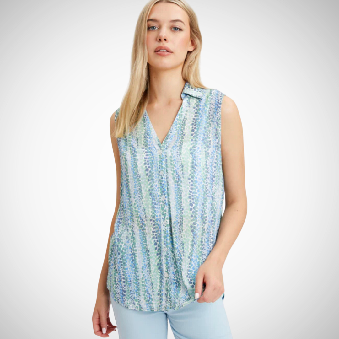 Jaboli Boutique - Port Dover Ontario - Blue And Green Dot Sleeveless Button Front Blouse. This button front blouse features a stylish print in shades of blue and green. With a collar and sleeveless silhouette, it falls to a hip-length with a sculpted hemline for an extra-flattering look. Plus, its cool comfort design provides all-day wearability.