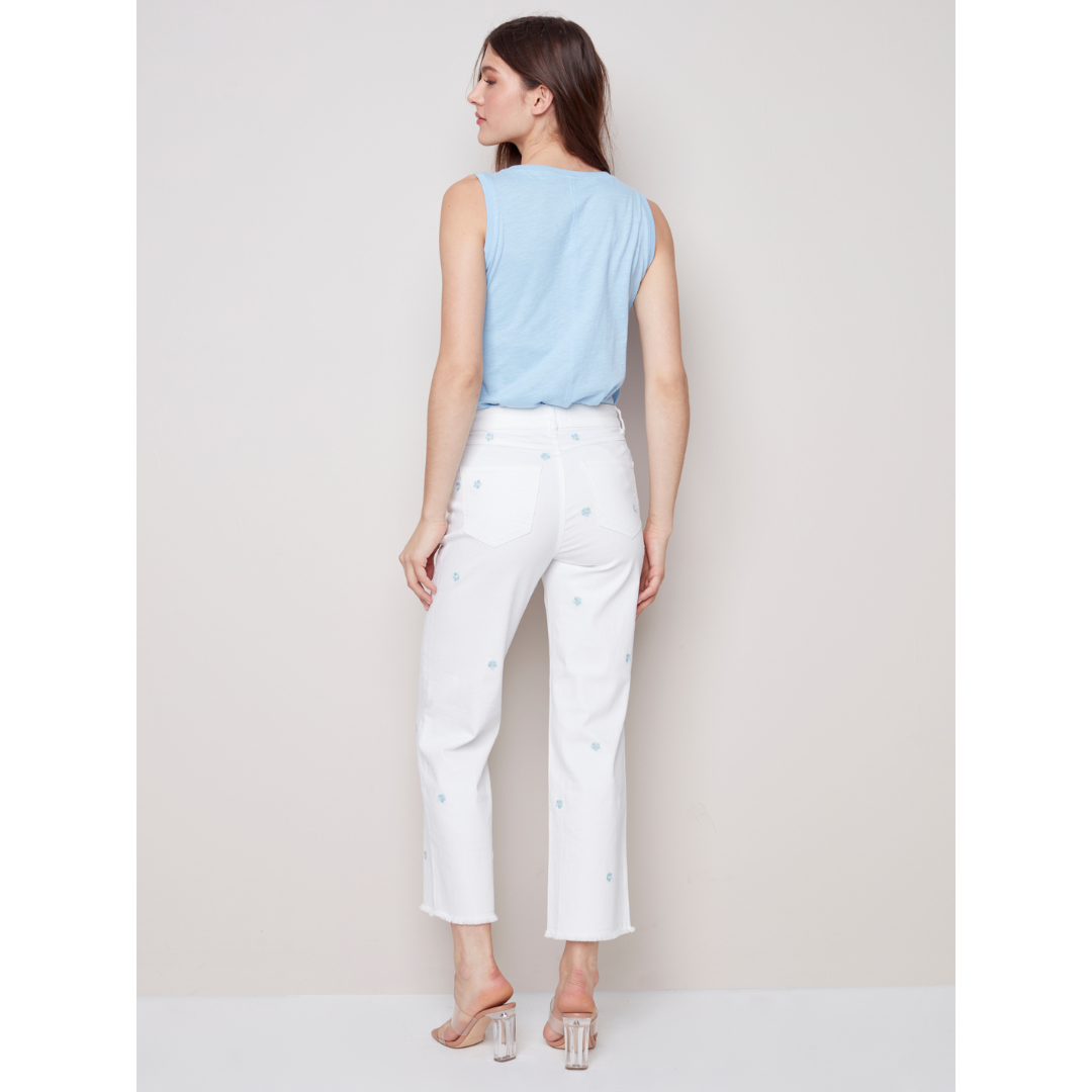 Jaboli Boutique - Fergus Ontario - Charlie B - Embroidered Flower Cropped Jeans White Denim High Rise Fly Front Wide Leg Frayed Hem. Emroidered Flowers Are Light Powder Blue with Yellow Centers.